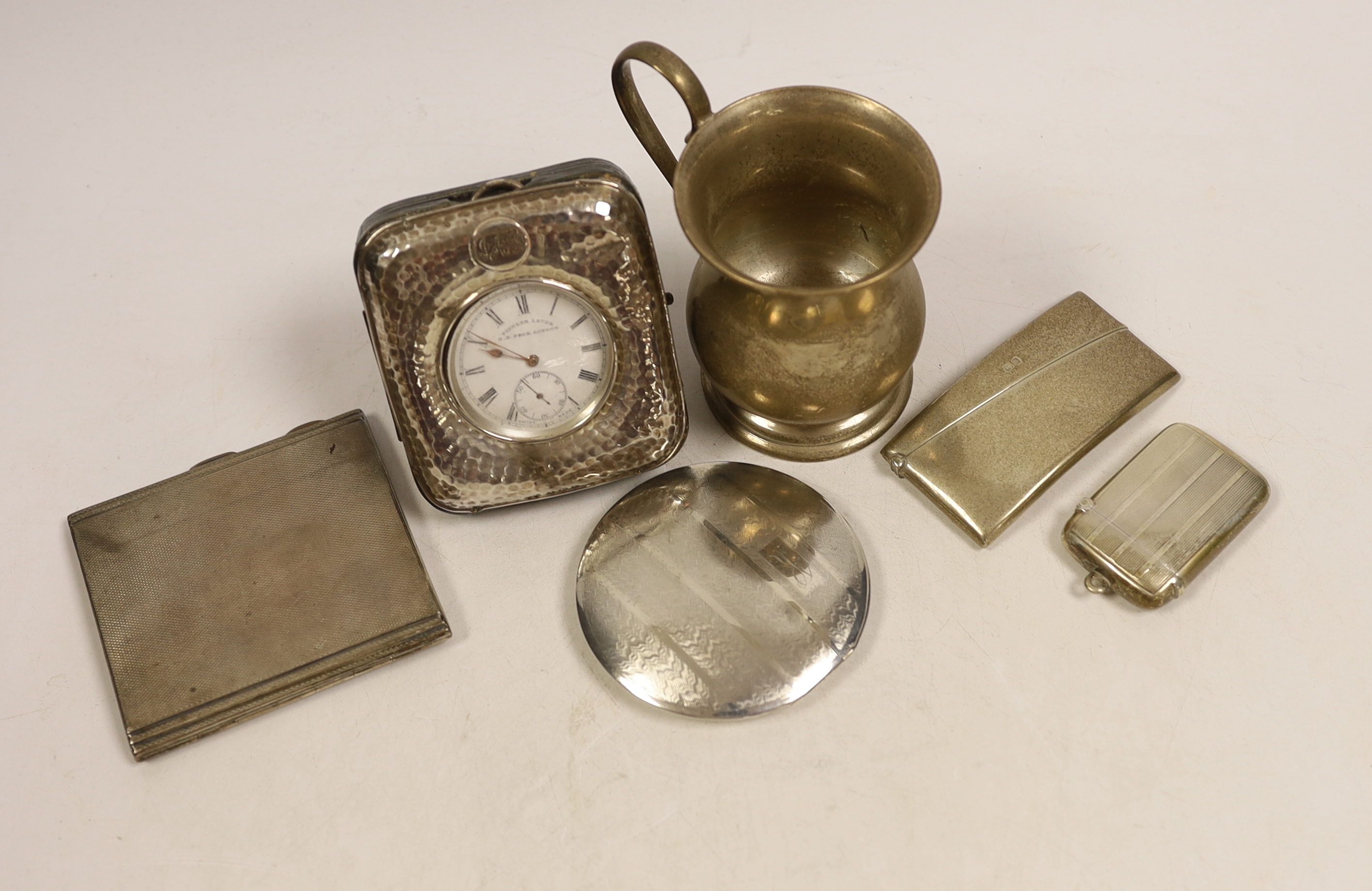 A George V silver baluster christening mug, height 9.7cm, an Edwardian silver mounted travelling watch case, containing a silver pocket watch by Peck of London, a silver card case, silver cigarette case, silver vesta cas